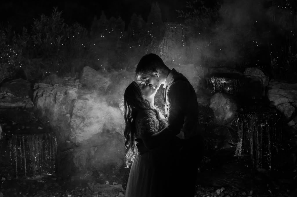 Black and white backlit couple embracing at night