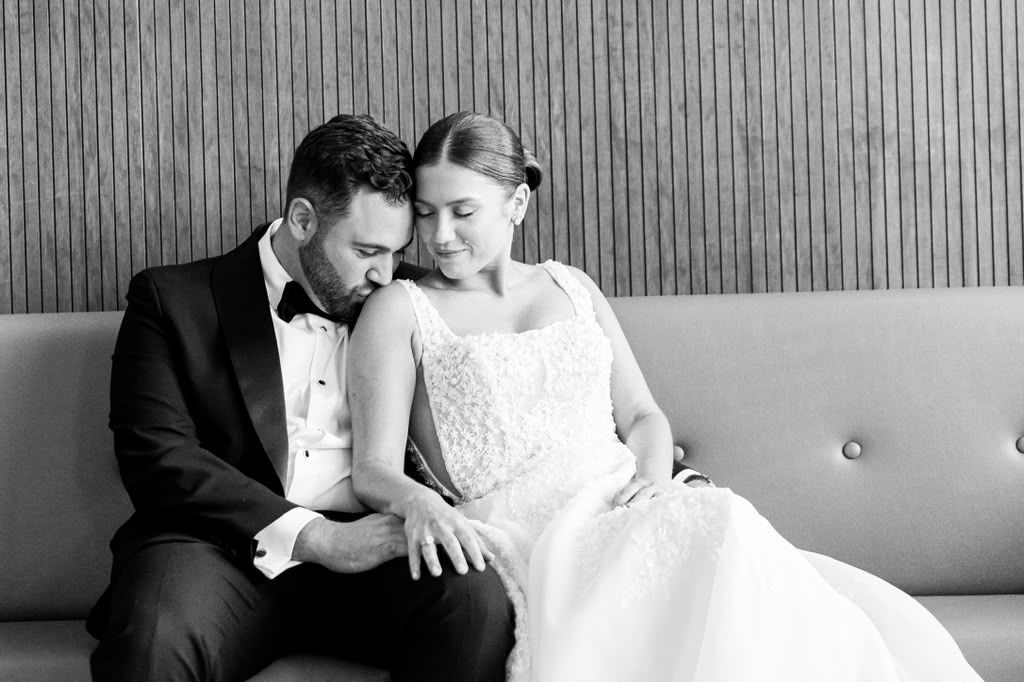 Black and white portrait of a couple on a lounge sofa