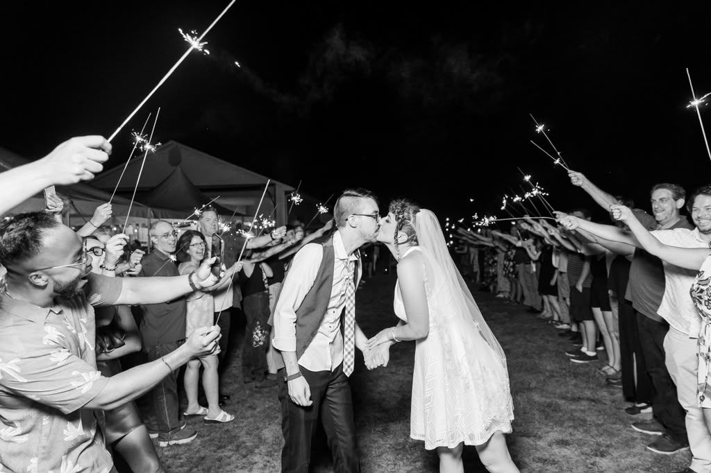 Black and white sparkler send-off with guests lining the path