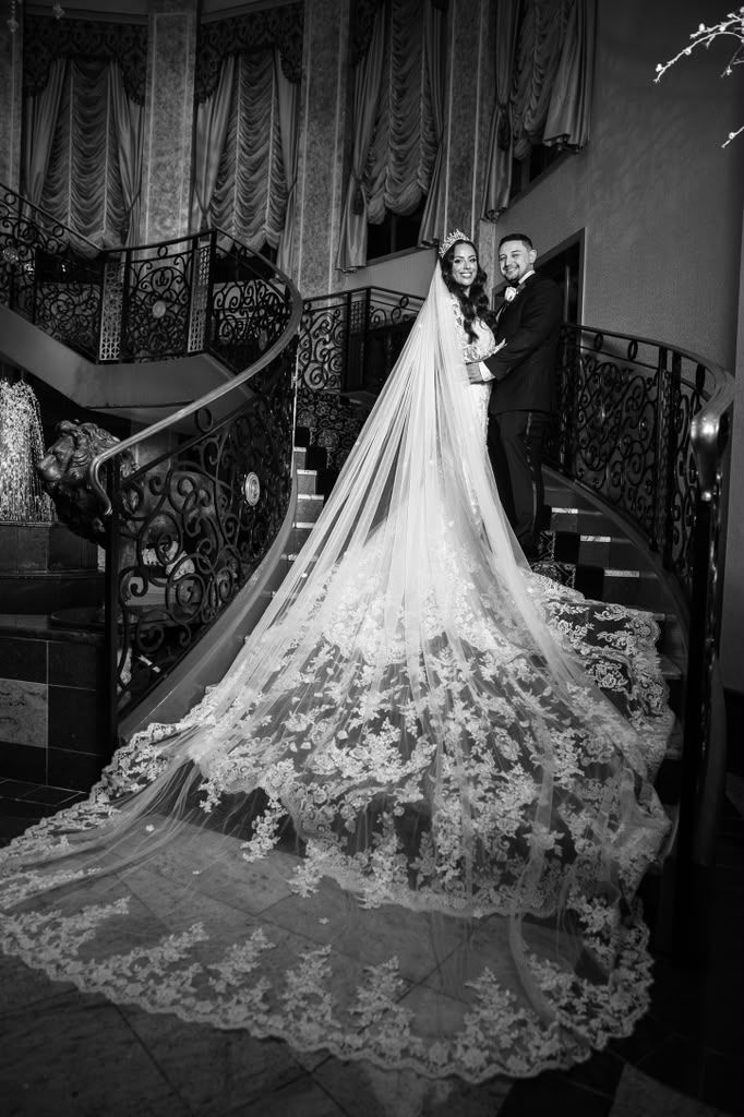 Cathedral-length lace veil cascading down a grand staircase
