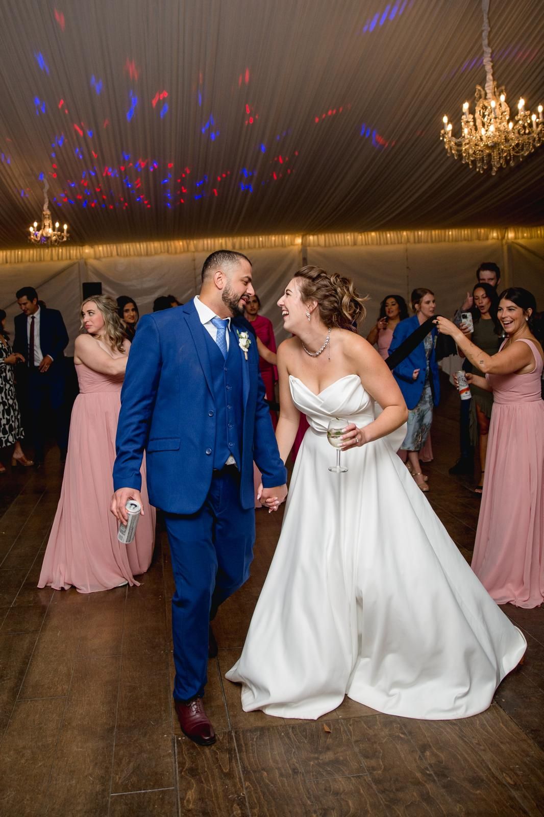 Bride and groom making a joyful grand entrance to their reception